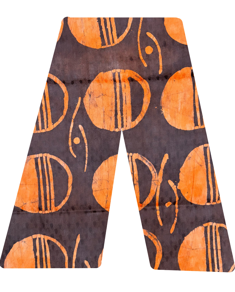 This is our traditional trousers. They are made from cotton. The pattern looks like half a sun, with three line seperating it from the moon in the colour orange on a brown background 