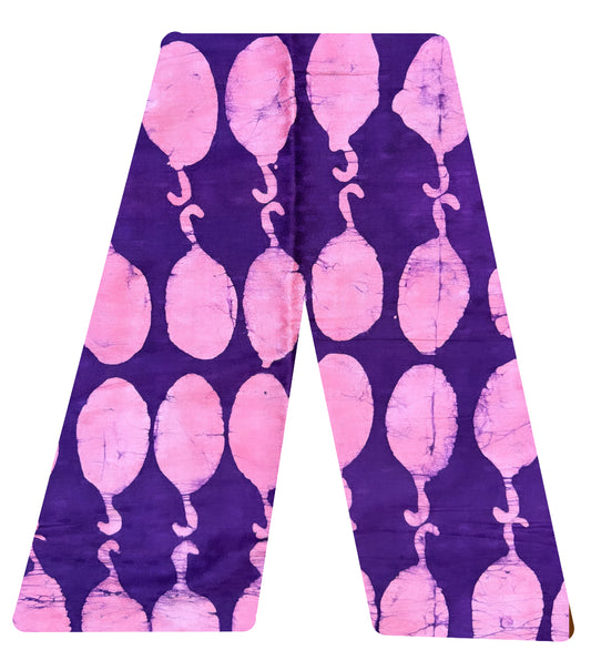 This is our traditional trousers. It is made from cotton.  The pattern looks like pink corn dogs on a deep purple background. 